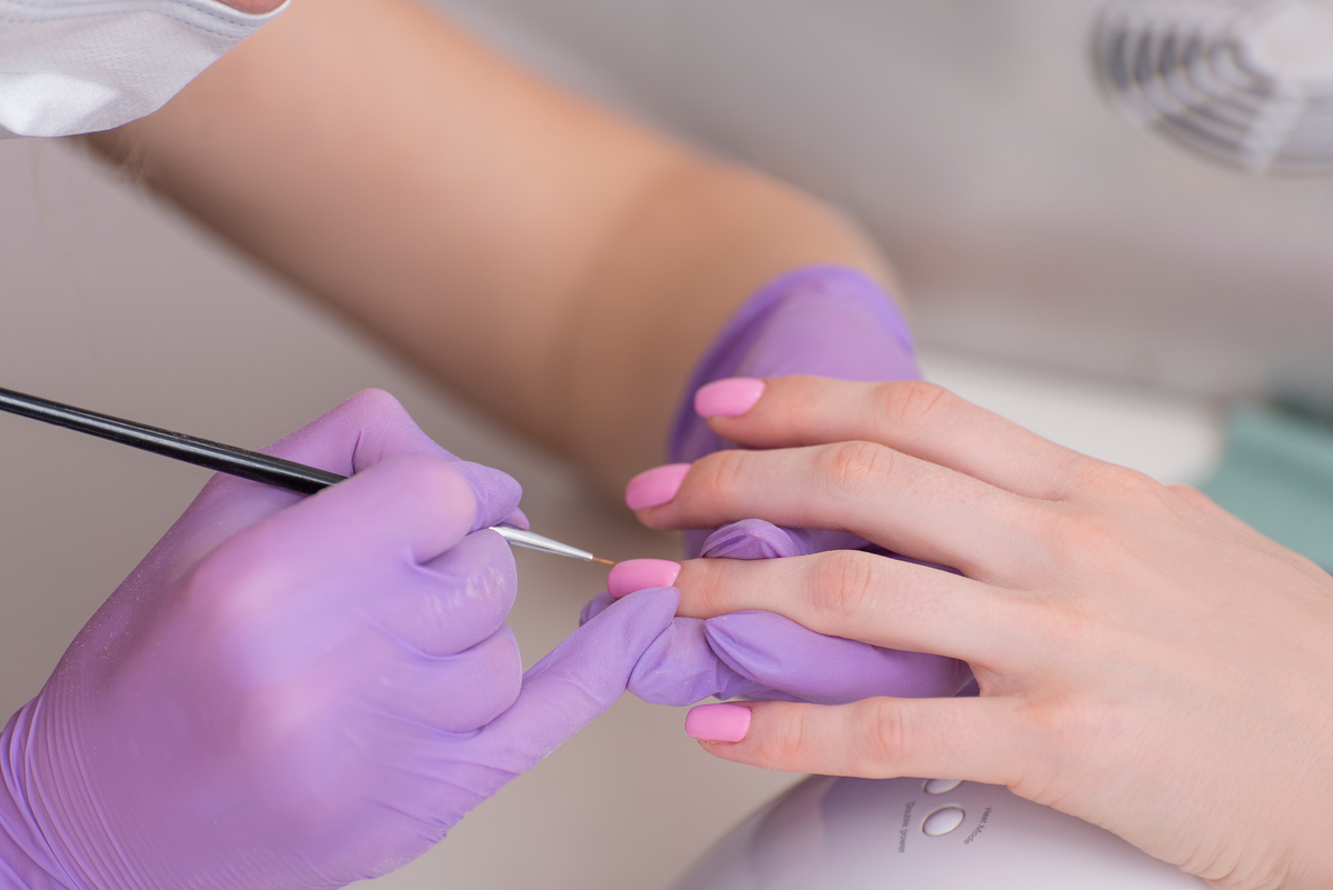 Covering Nails with Pink Nail Polish